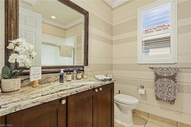 Bathroom with tile floors, ornamental molding, van