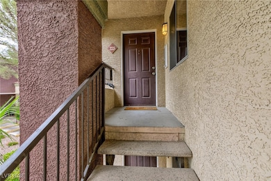Property entrance featuring stucco siding and a porch