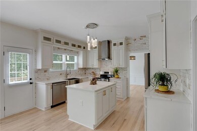 Kitchen with stainless steel appliances, wall chim