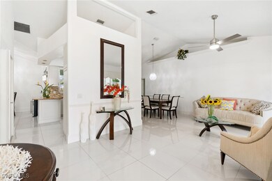 Living room with light tile patterned floors, high
