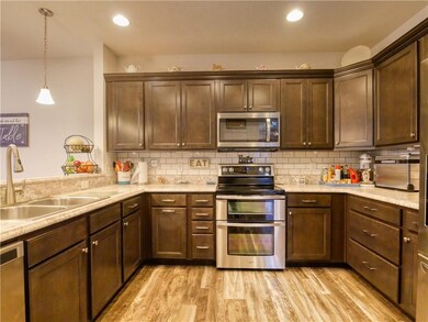 Gorgeous kitchen with beveled counter, double oven, subway tile backsplash and cabinets with crown molding. All appliances included!