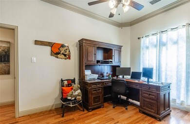 Office featuring a wealth of natural light, ceiling fan, ornamental molding, and hardwood floors