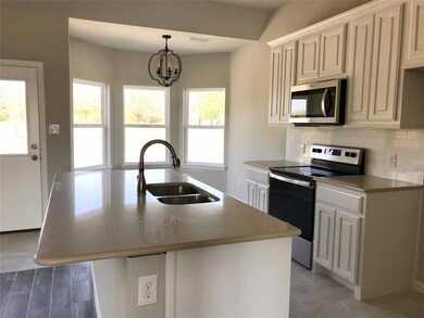 Spacious kitchen with quartz countertops, island, 