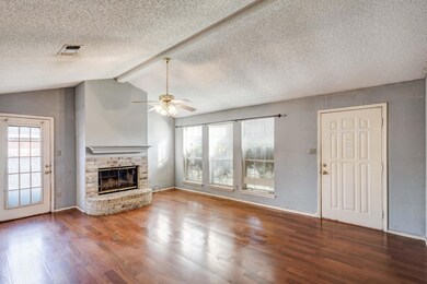 Unfurnished living room featuring a fireplace, woo