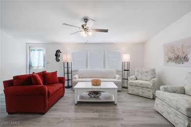 Living room with wood-type flooring and ceiling fa