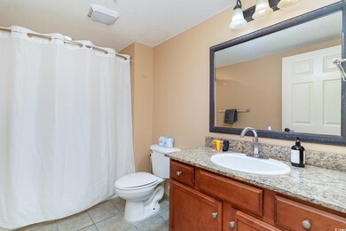 Bathroom featuring toilet, tile patterned flooring