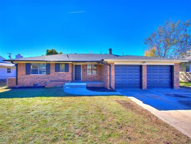 Ranch-style home with a front lawn and a garage