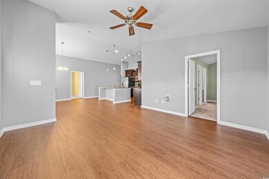 Unfurnished living room featuring ceiling fan with