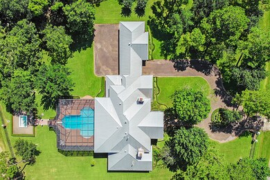 An aerial view of the property with its amenities and mature greenery