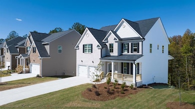 Traditional-style home with a front lawn, driveway