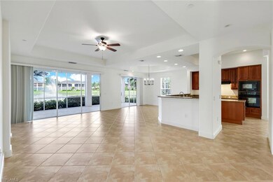 Unfurnished living room with a tray ceiling, sink,
