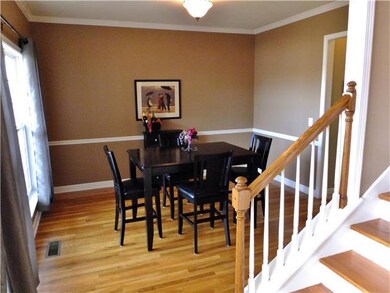 Spacious Formal Dining Room with Hardwood Flooring and Floor to Ceiling windows. Perfect for entertaining! 