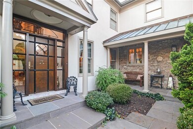 Custom designed wood, iron and brass entry door.