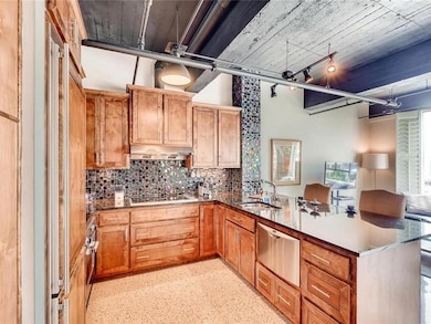 Kitchen with a warming drawer, a peninsula, stain