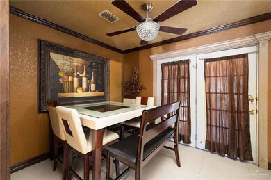 Dining area featuring ornamental molding, french doors, a textured wall, light tile patterned floors, and ceiling fan