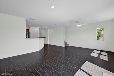 Unfurnished living room with ceiling fan