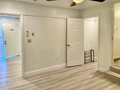 Unfurnished bedroom with light wood-style flooring and ceiling fan