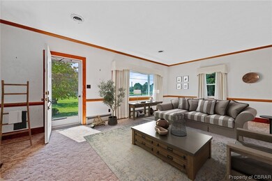 Carpeted living room with baseboard heating and cr
