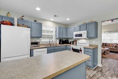 Kitchen with wood-type flooring, blue cabinetry, a