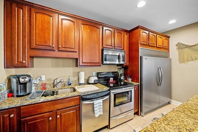 Kitchen with light tile patterned floors, light st