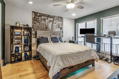 Bedroom with light wood finished floors, recessed