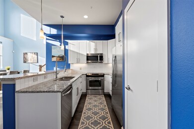 Open, galley shaped kitchen with new countertops,