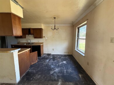 Kitchen featuring ornamental molding, black dishwa
