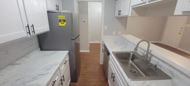 Kitchen featuring freestanding refrigerator, whit