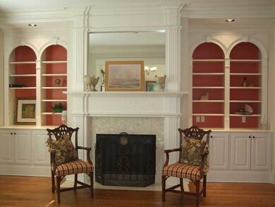 Living room has built in cabinets & shelves w/fire
