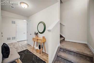 foyer with access to garage, storage, and backyard