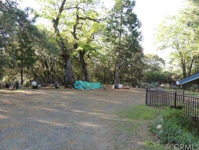 Fenced in yard with mature trees.