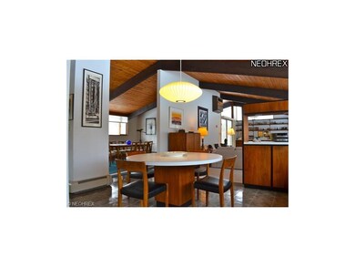 Large eat-in kitchen with wall of windows opening 