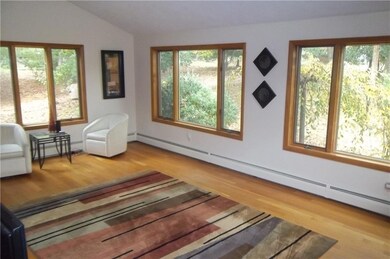 Sunken living room with hardwood floors, lots of w