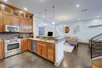 Kitchen featuring visible vents, a sink, concrete