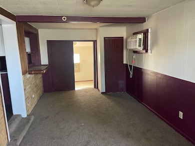 Hall with a wall mounted AC, wood walls, beam ceil