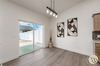 dining area with patio door to fenced & landscaped