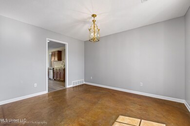 Formal dining with stained concrete floor.