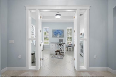 Corridor featuring a desk and light tile patterned floors