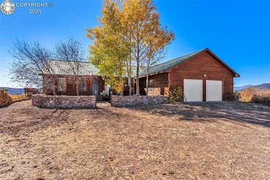 View of front facade featuring a patio and a garage