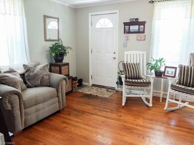 Front room/Foyer with wood flooring and crown mold
