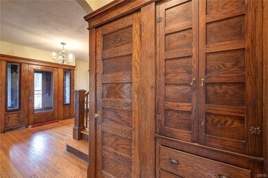 ***** VIEW OFOAK CLOSET AND CABINETS IN FOYER***