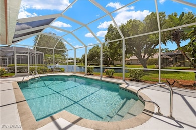Pool with a water view, a patio area, and a lanai