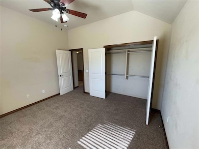 Unfurnished bedroom featuring dark colored carpet,