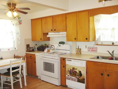 Bright and cheery Kitchen with hardwood flooring a