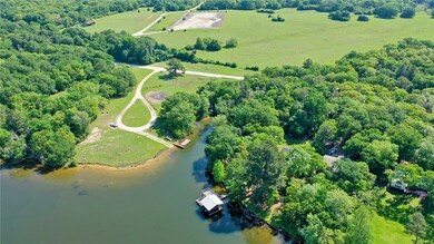 Birds eye view of property with a water view and a