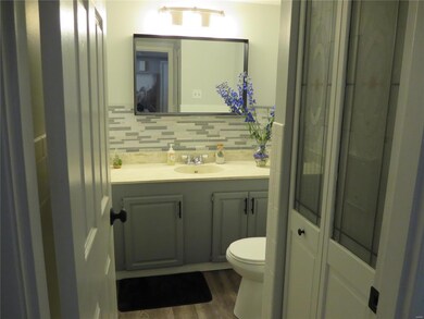 Half bath has been updated with tile back splash a