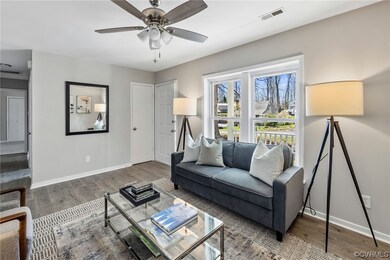 Living room featuring natural light, a ceiling fan