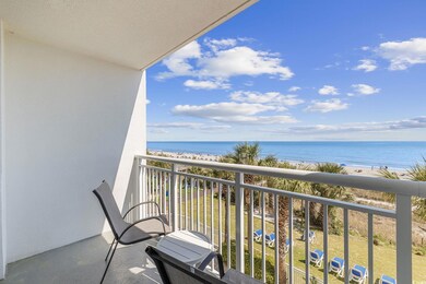 Balcony with view of water and beach