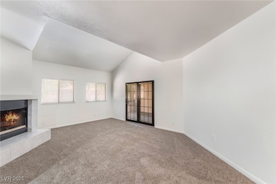 Unfurnished living room with carpet, a fireplace,