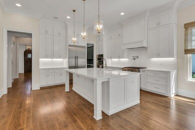 Perfect for cooking and entertaining! Powder and laundry rooms are located conveniently to the left.